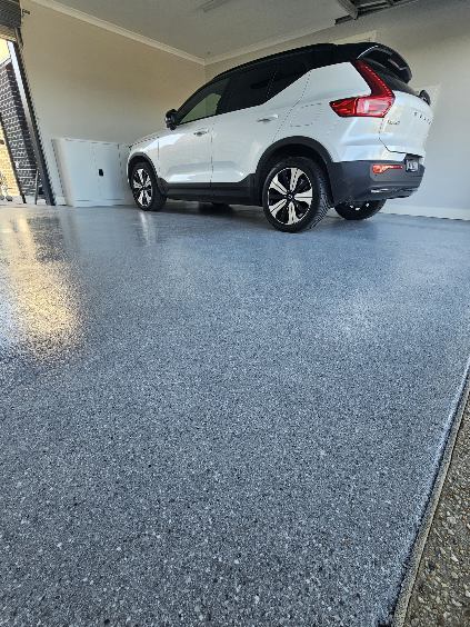 flake system flooring in the garage with the car already on it and ready to go
